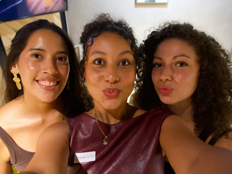 Three women taking a selfie at a dinner